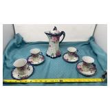 Hand-painted tea pot with 4 cups and saucers,