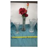 Crystal vases some with artificial flowers, right