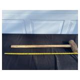 Long handled wood sledge hammer.