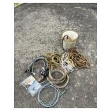 Bucket with bungee cords, rope and straps.