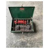 Coleman propane camp stove in case.