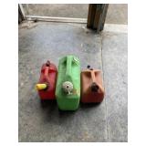 Two 1.5 gallon gas jugs and green 3 gallon water
