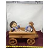 Wood wagon and porcelain dolls.