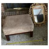 Stepstool and plastic framed mirror.