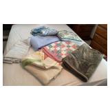 Throw blankets and pillows and a comforter