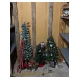 Three small Christmas trees one lights up.