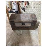 Old trunk with comforter.