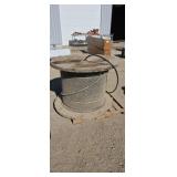 Large wood spool with copper wire approximately