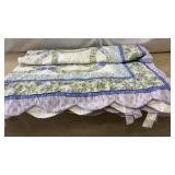 Decorative quilted cushion featuring a floral and