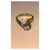 14K gold ring set with a single brilliant-cut