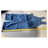 John Deere denim overalls with a medium wash and