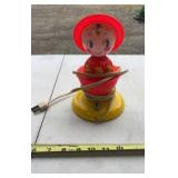 1950s celluloid baby lamp features a charming red