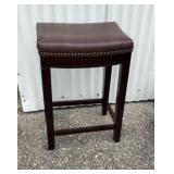 Barstool with dark brown faux leather saddle seat