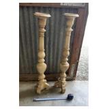 Tall, whitewashed wooden candlesticks featuring a
