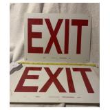 Pair of Exit signs . One has a crack