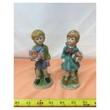Hummel-Style Ceramic Figurines Feature a Boy and