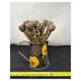 Wooden Textile Bobbins in Metal Pitcher