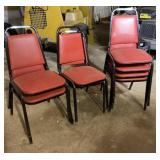 Eight Cushioned Red Metal Chairs Some with Holes