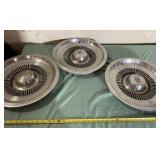 Three Buick Electra 225 Wheel Covers One Bent