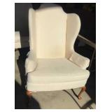 Vintage cream-colored wingback armchair