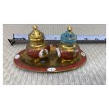 Enameled brass salt and pepper shakers with a
