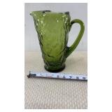 Avocado green glass pitcher with a textured,