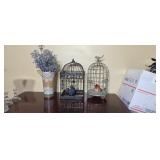 Two wire bird cages and a flower vase