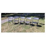 Five Costco plastic folding chairs