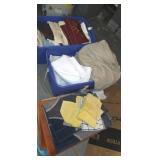 Two totes full of sheets rugs blankets