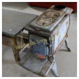 USED CAST IRON WOOD BURNING STOVE.