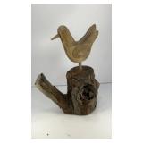 Wooden bird sculpture on natural stump base