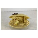Plastic clam shell with carving scene inside
