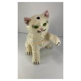 Glossy ceramic white cat with green eyes
