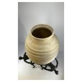 Ceramic vase on iron stand of (3) human figures