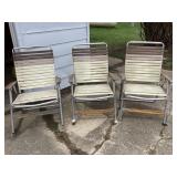 3 folding chairs, one is a rocker