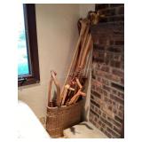 Collection of walking sticks in basket, 20 total