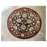 Round area rug that measures 50" diameter