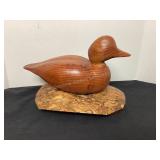 Carved wood duck on what looks to be burl wood