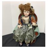 Geppeddo porcelain sitting doll and chair