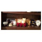 Shelf of tea cups, candles & collectible decor