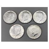 Five 1964 Kennedy half dollars