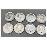 Eight 1964 Kennedy half dollars