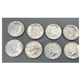Eight 1964 Kennedy half dollars