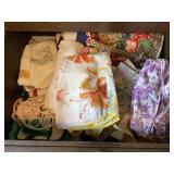 Kitchen Drawer Contents; aprons, towels, cover,