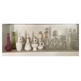 Shelf of decorative Avon bottles & more