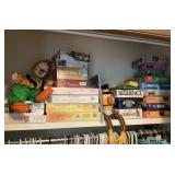 Shelf of puzzles, games, vintage Bert puppet &