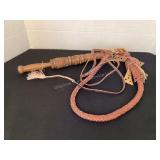 Leather whip with carved wood handle