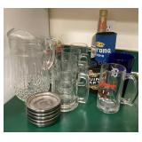 Beer steins, glass pitcher, coasters, cookies &