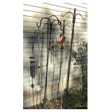 Shepherd hooks, wind chimes, decorative cross.