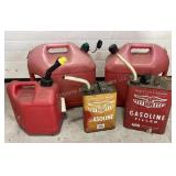 5 gas cans, one has a small amount of liquid